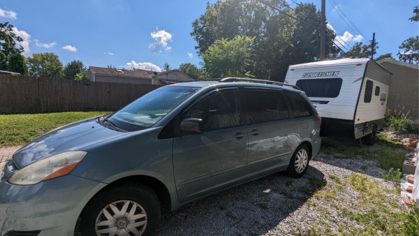minivan pulling a small camper 