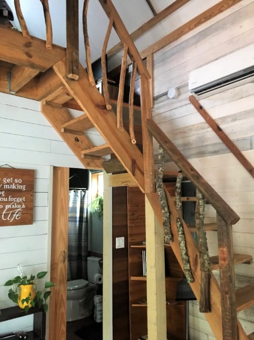 One of a kind staircase up to the loft area of the Airbnb.