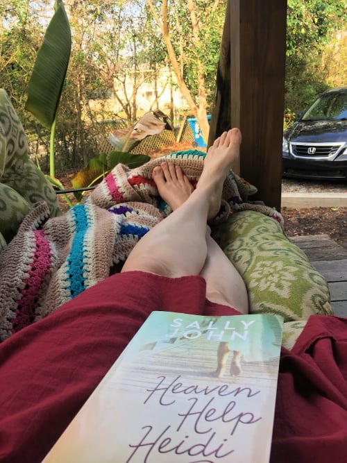 Enjoying a good book on the front porch at our Airbnb.