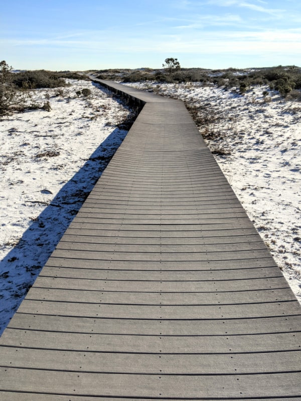 Boardwalk through the sand dunes of Fort Pickens National Seashore. 