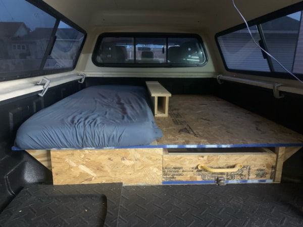 Creating a divider night stand area in our truck cap camper for two people. 