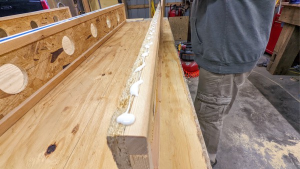 Add the glue to the DIY truck topper bed supports.