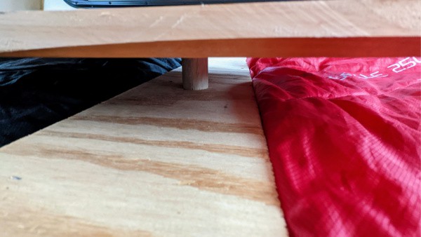 How the table is secured into the middle divider in our self-built truck camper. 