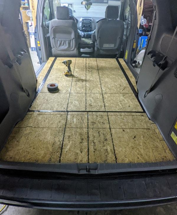 The minivan now has a level plywood subfloor and is ready for flooring. 