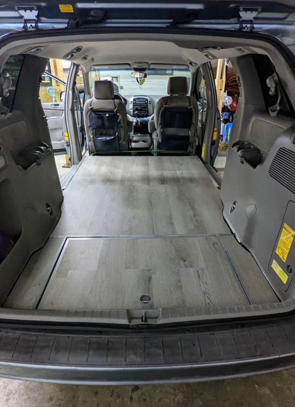 Second and third-row seats were removed in a minivan to make way for a level floor. Now it can be used as a camper van or a cargo van. 