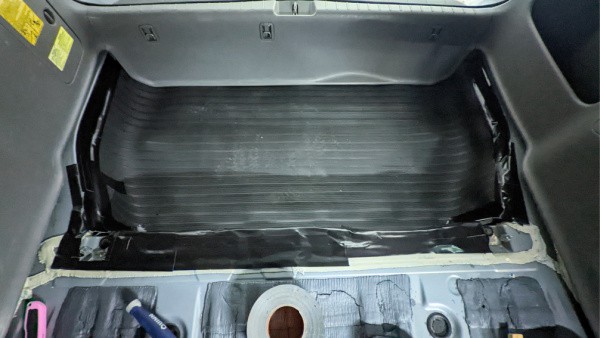 Duct tape and a utility knife helped us shape the mat into a new trunk liner for the minivan. 