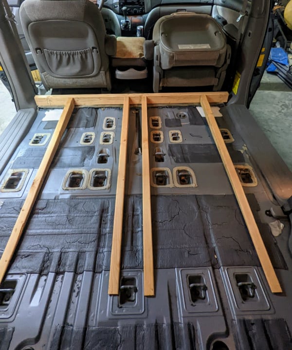 Where the four support beams for the level floor of the minivan cargo van will sit. 