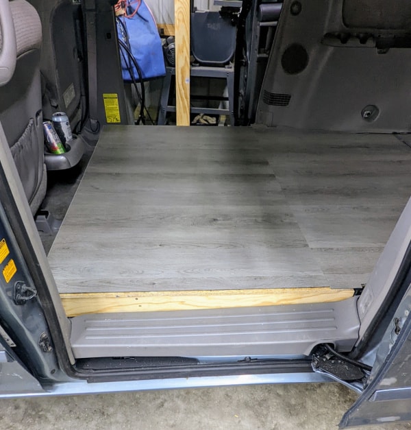 What the edge of the van floor near the sliding door looks like without trim. 
