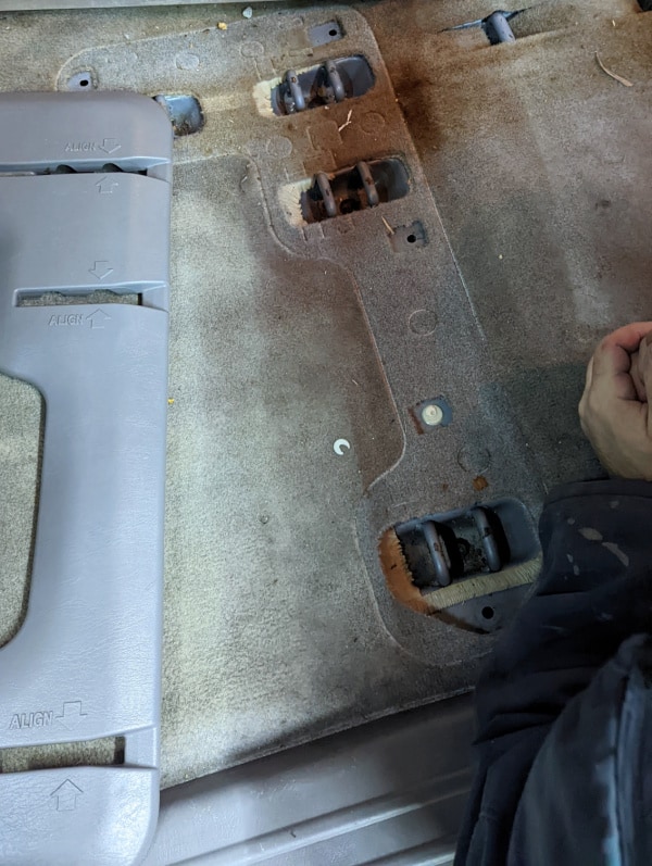 Level van floor prep: Removing the middle seat connector caps. 