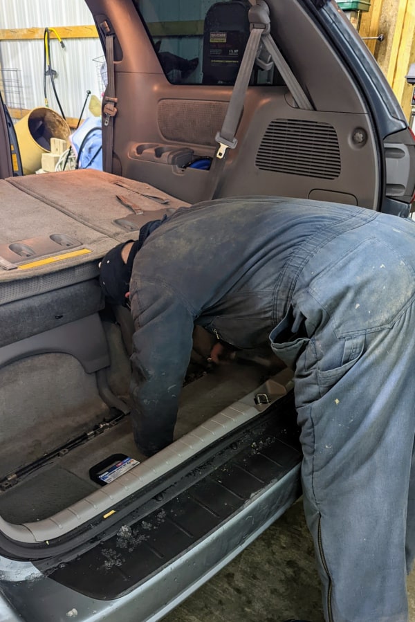 Removing the seats in a minivan to cargo van conversion. 