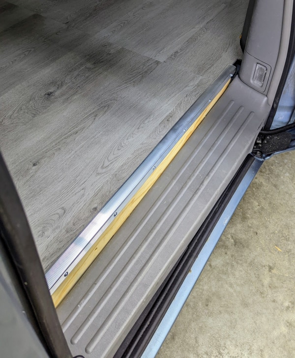 What the level floor of the minivan near the sliding door looks like with trim. 