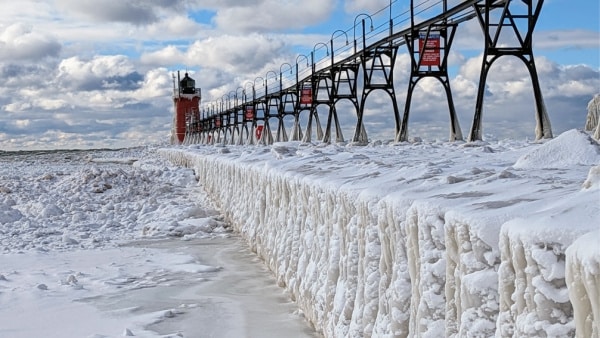 The ice covered lighthouse and catwalk of South Haven, Michigan.