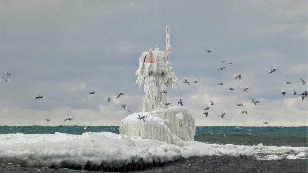 St. Joseph, South Pier Beacon covered in ice during winter storm. 