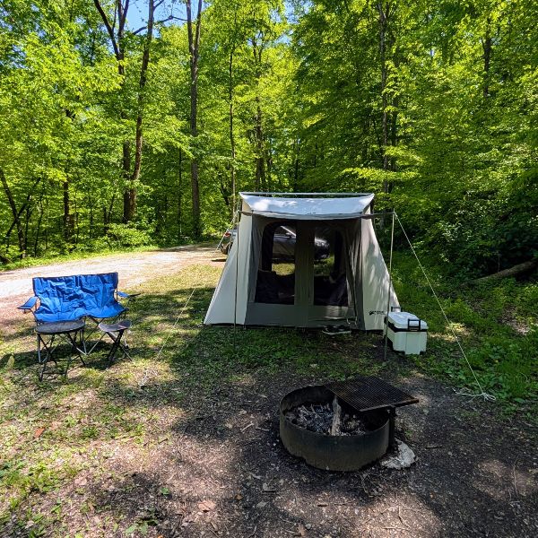 canvas tent set up at a campsite.